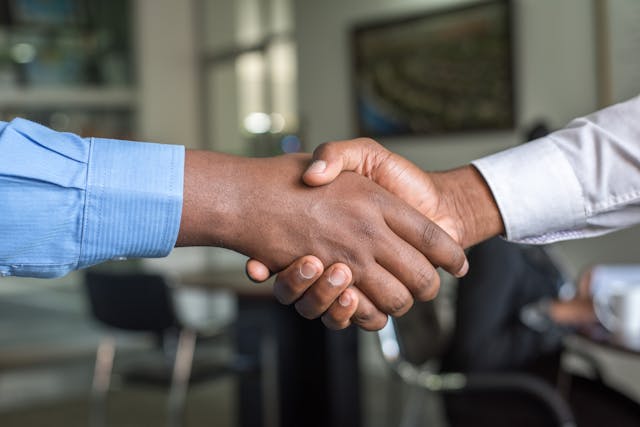 A handshake representing Customer Commitment